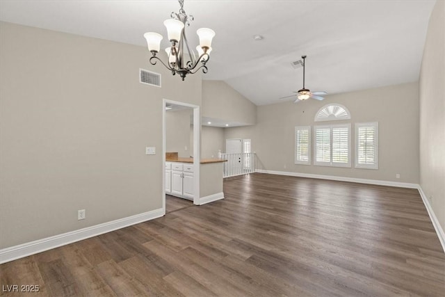 unfurnished living room with ceiling fan with notable chandelier, dark wood finished floors, visible vents, and baseboards