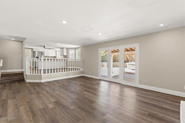 unfurnished living room featuring dark hardwood / wood-style floors