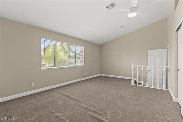 carpeted empty room with vaulted ceiling and ceiling fan