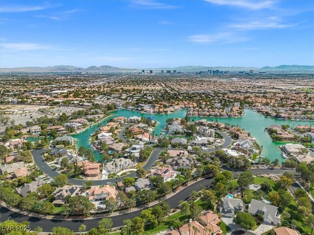 birds eye view of property featuring a water and mountain view