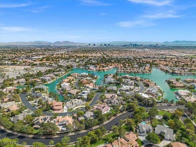 drone / aerial view with a residential view and a water and mountain view