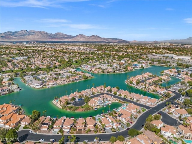 drone / aerial view featuring a water and mountain view