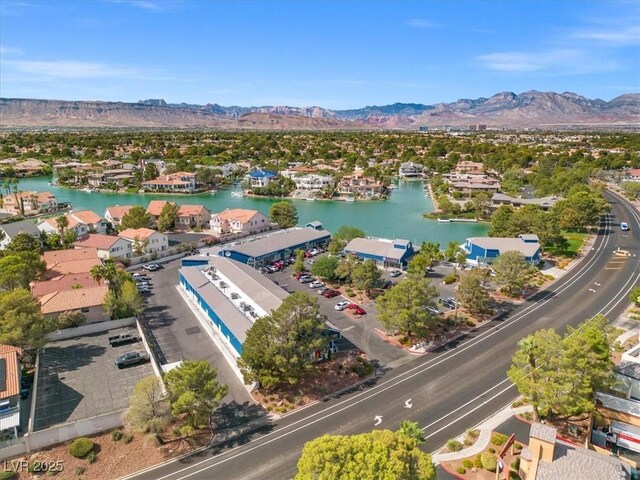 birds eye view of property with a water and mountain view