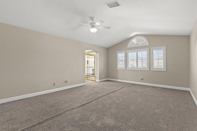 empty room featuring carpet floors, ceiling fan, and vaulted ceiling