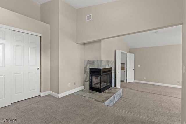 unfurnished living room featuring high vaulted ceiling, light carpet, and a fireplace