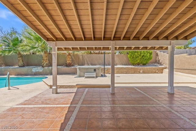 view of patio with a hot tub, a fenced in pool, and a fenced backyard