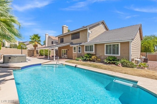 view of swimming pool featuring a patio, a fenced backyard, a fenced in pool, and a hot tub