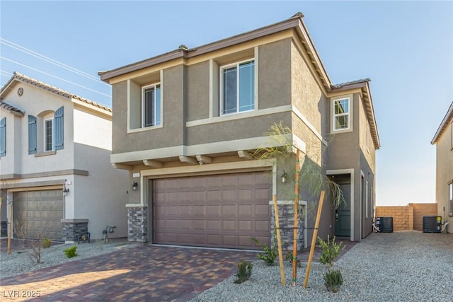 view of front of property with a garage and central air condition unit