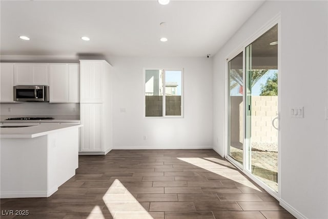 kitchen featuring white cabinetry, dark wood-type flooring, and a wealth of natural light