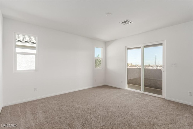 spare room featuring light colored carpet