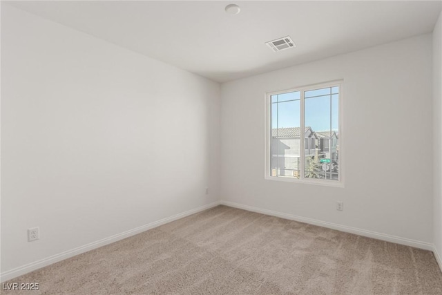 empty room with light colored carpet