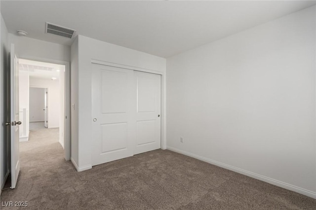 unfurnished bedroom with carpet floors and a closet