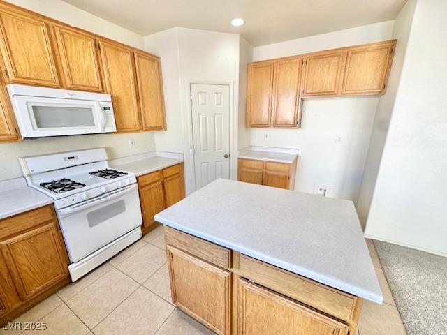 kitchen with white appliances and light tile patterned floors