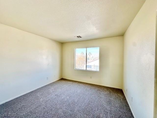 carpeted empty room with a textured ceiling