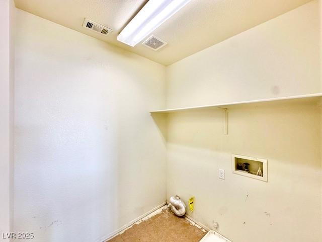 clothes washing area featuring gas dryer hookup and washer hookup