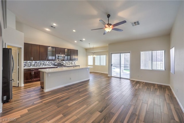 kitchen with visible vents, stainless steel appliances, light countertops, dark wood-type flooring, and open floor plan