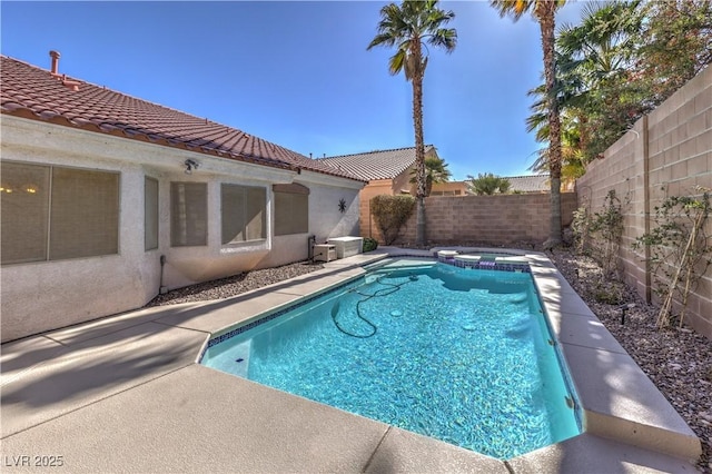 view of pool featuring a pool with connected hot tub and a fenced backyard