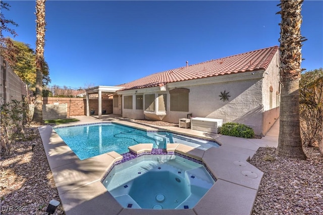 view of pool with a patio area, a pool with connected hot tub, and a fenced backyard