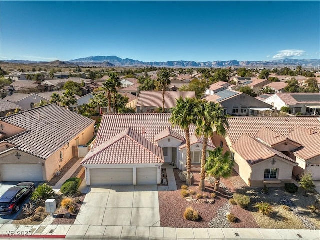 drone / aerial view featuring a residential view and a mountain view