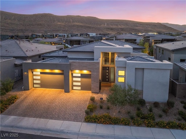 view of front of property with a mountain view and a garage