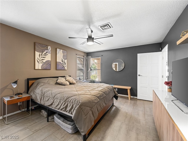 bedroom with ceiling fan, a textured ceiling, and light wood-type flooring