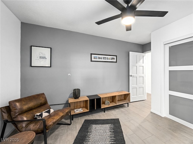 living area with ceiling fan and light hardwood / wood-style floors