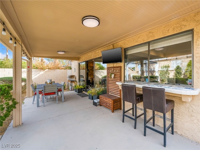 view of patio / terrace featuring an outdoor bar