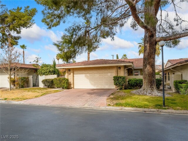 single story home with a garage and a front yard