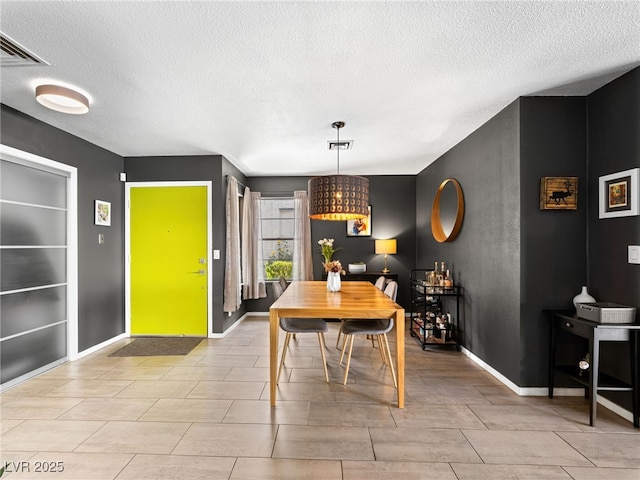 dining room featuring built in features and a textured ceiling