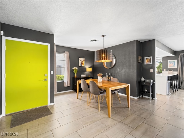 dining space featuring a textured ceiling