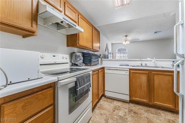 kitchen featuring sink, white appliances, ceiling fan, kitchen peninsula, and a textured ceiling