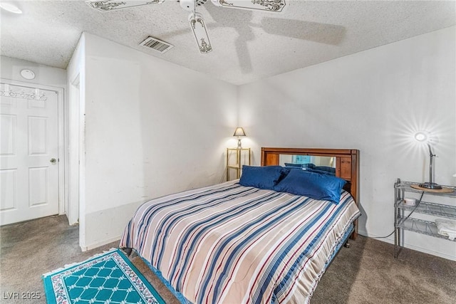 carpeted bedroom with ceiling fan and a textured ceiling