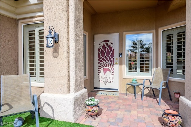 entrance to property featuring a patio area