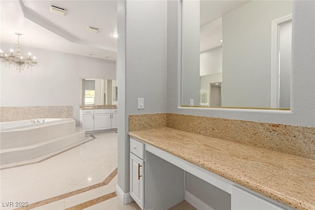 bathroom with vanity, a notable chandelier, tile patterned floors, and tiled bath