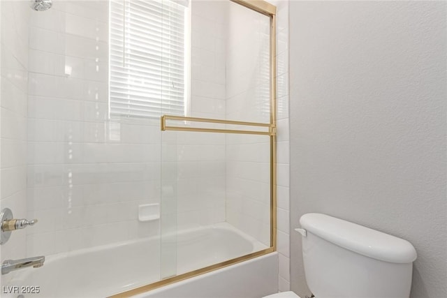 bathroom featuring shower / bath combination with glass door and toilet