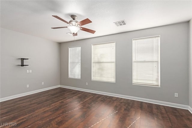 empty room featuring dark hardwood / wood-style floors and ceiling fan