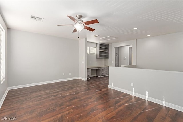 unfurnished living room featuring dark hardwood / wood-style flooring and ceiling fan