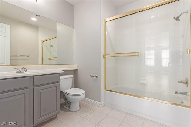 full bathroom featuring toilet, tile patterned floors, bath / shower combo with glass door, and vanity