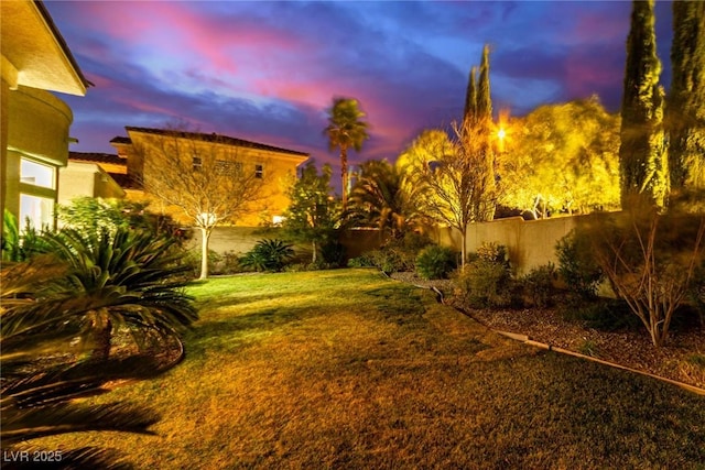 view of yard at dusk