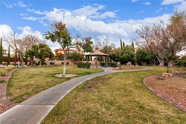 view of property's community with a yard and a gazebo