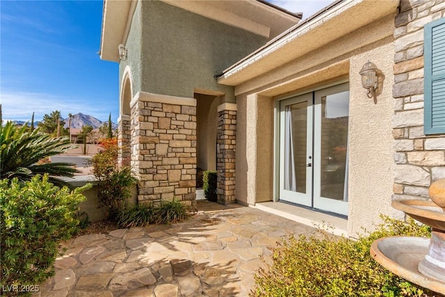 view of exterior entry featuring a patio and french doors