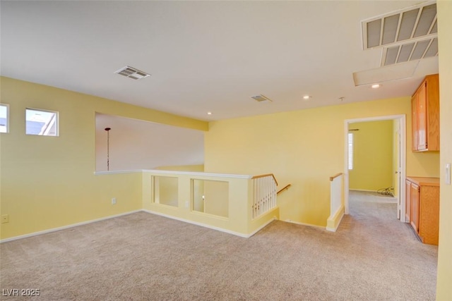 unfurnished room featuring light carpet