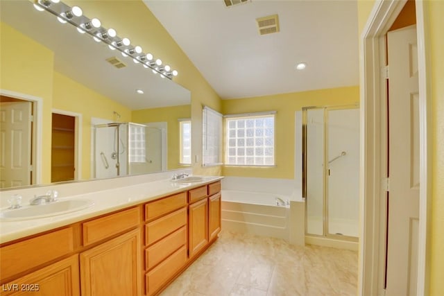 bathroom featuring lofted ceiling, vanity, separate shower and tub, and tile patterned floors