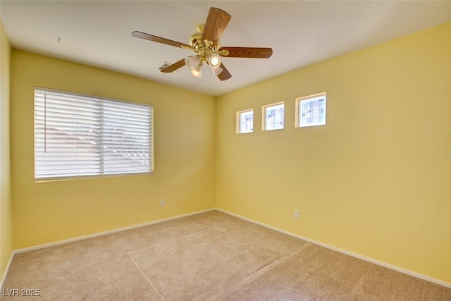 spare room with light carpet and ceiling fan