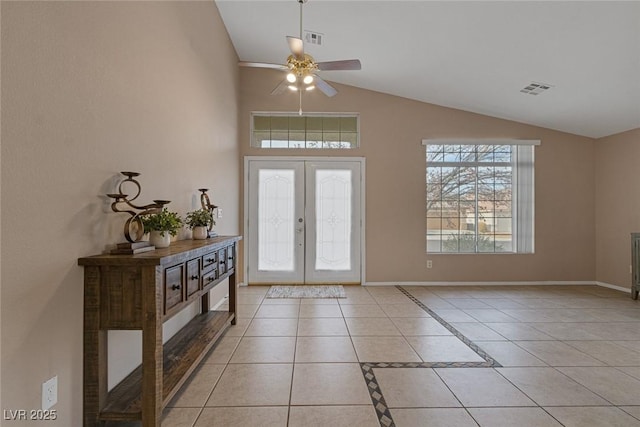 tiled foyer with vaulted ceiling, ceiling fan, and french doors