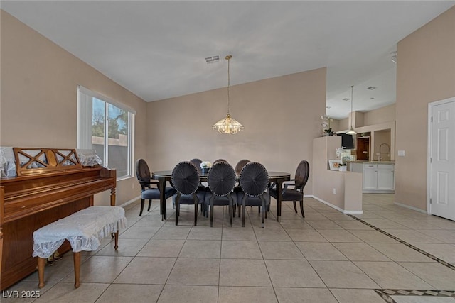 dining room with light tile patterned floors and a chandelier