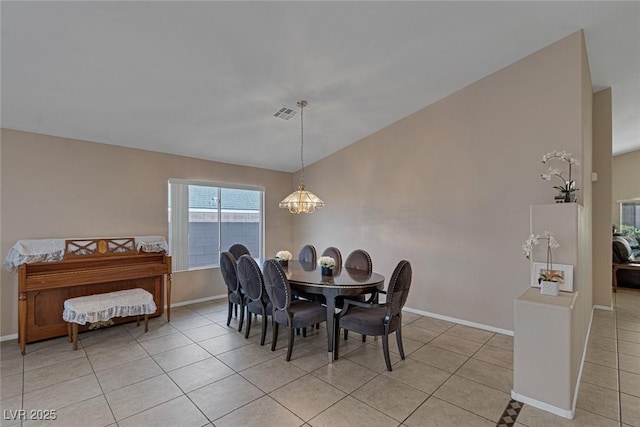 dining room with a notable chandelier and light tile patterned floors