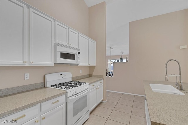 kitchen featuring white appliances, sink, and white cabinets