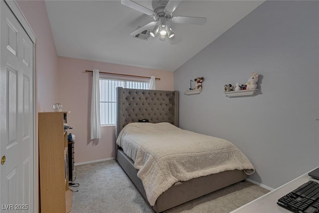 bedroom featuring vaulted ceiling, light colored carpet, and ceiling fan