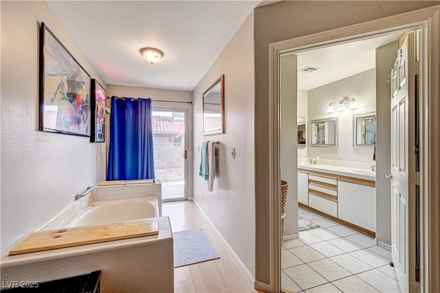 bathroom featuring vanity and a tub to relax in